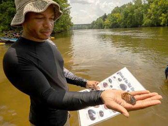 A man checking out some local mussels in the Flint River, GA.
