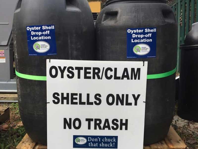 two black bins for collecting oyster shells