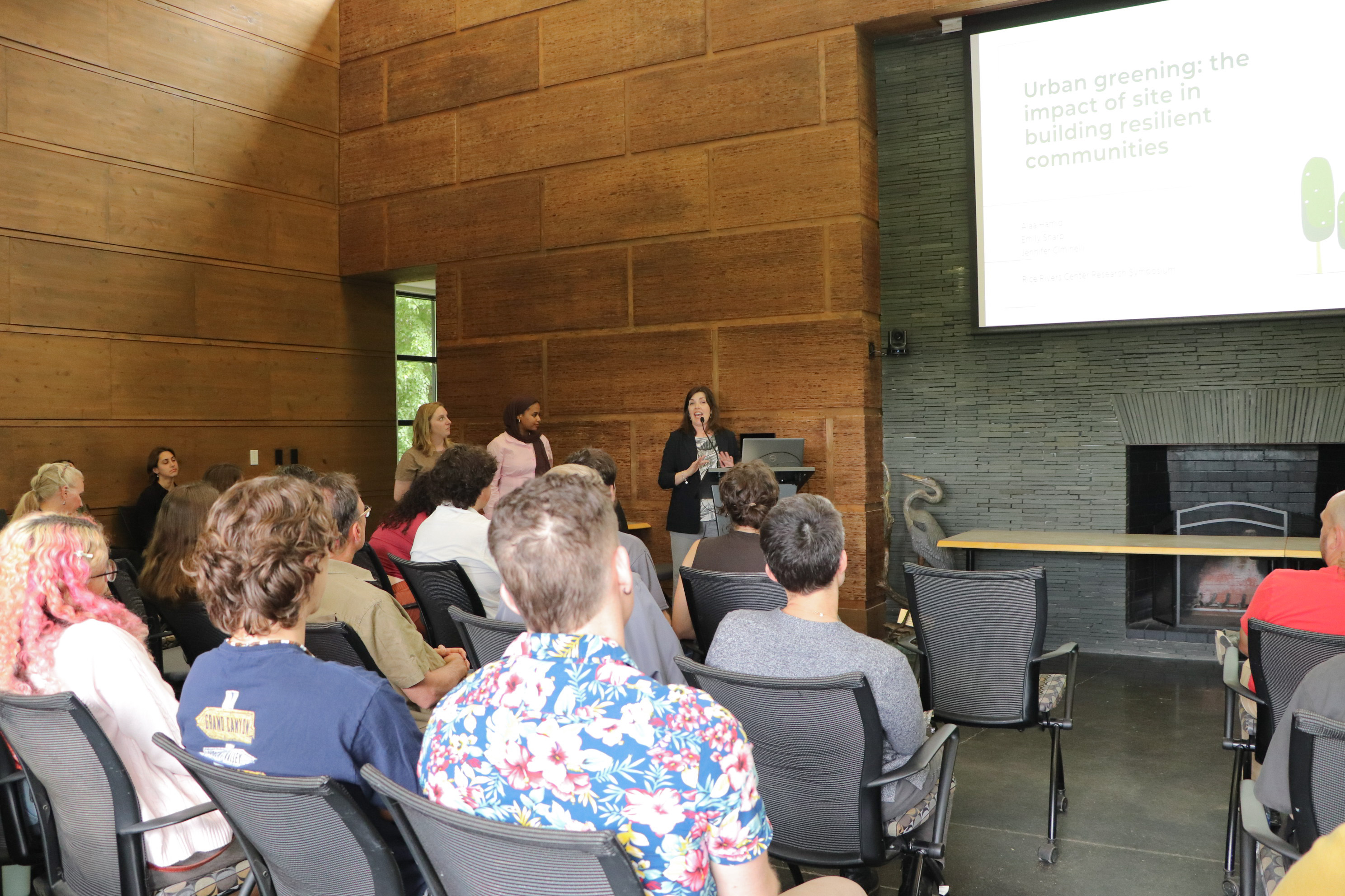 A group of faculty and students watch a presentation during the Rice Rivers Center Research Symposium at the Walter L. Rice Education Building.