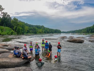 Field training safety exercise, people are standing in knee high water in the James River.